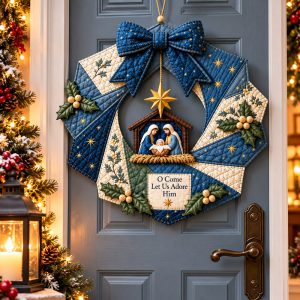 Nativity quilted Christmas wreath sewing pattern with blue bow on a gray front door